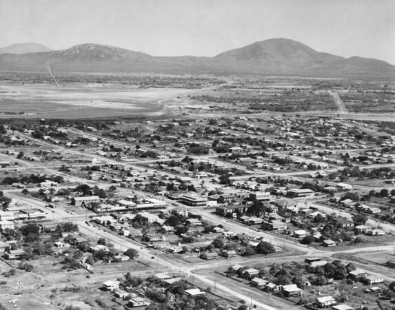 Black and white aerial image of beachside suburb 1950s