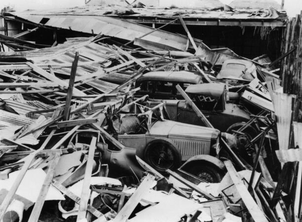 Vintage cars amid wreckage of building