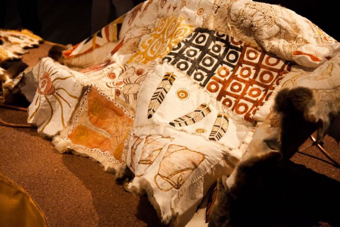 Brisbane Community Cloak, a possum skin cloak decorated in Aboriginal artwork featuring feathers, baskets, and other designs