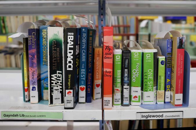 Library books on a shelf labelled Gayndah, Inglewood