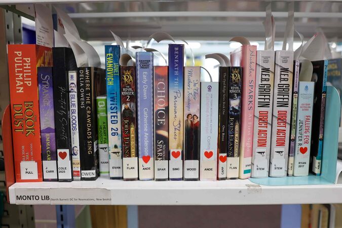 Library books on a shelf labelled Monto