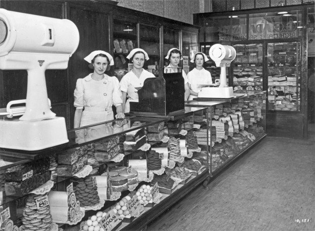 Staff behind the counter at George E. Adams' cake shop, Brisbane Arcade