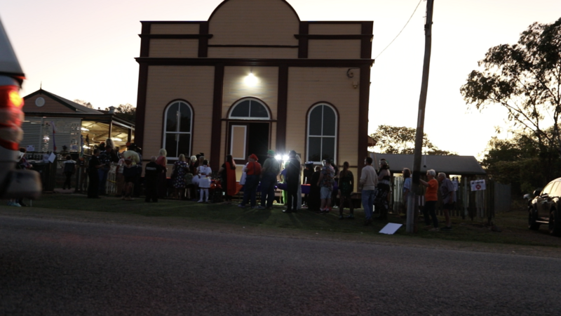 Queueing for the Halloween Ball outside the School of Arts Hall.