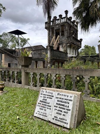 View of the the Castle from the cottage and memorial plaques for José and Margarita Paronella, Paronella Park.