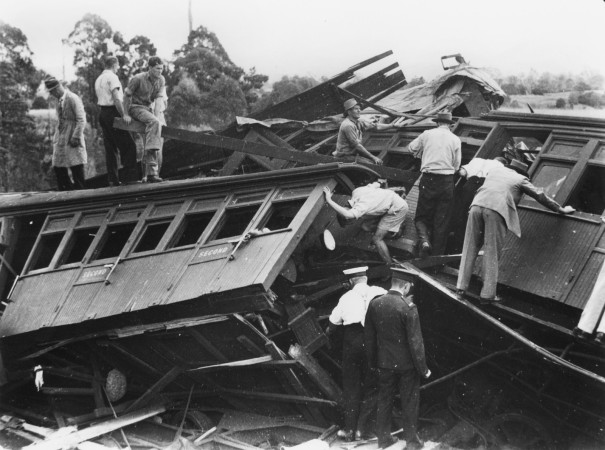 A jumble of carriages derailed and rescuers and passengers clamoring to help others in need