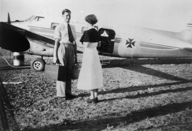 Man and woman in front of medical aircraft in the 1950s