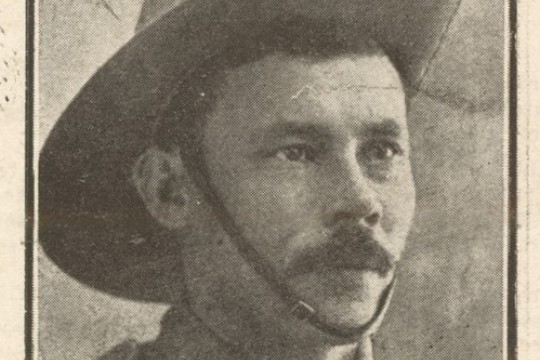 Soldier portrait man in uniform with dark hair and moustache wearing hat with strap under the chin