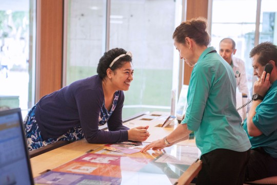 Client speaking to reception staff at the State Library of Queensland