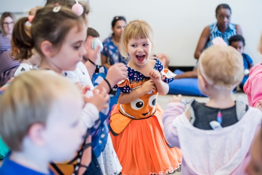 Children wearing costumes and dancing