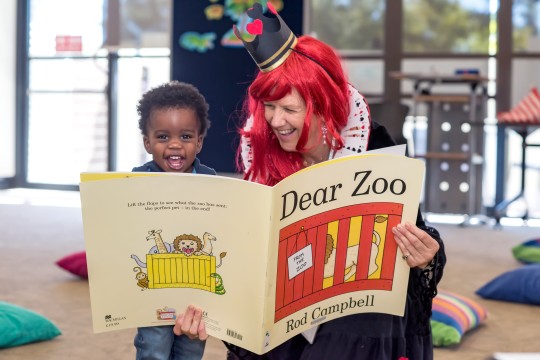 Library staff read giant book version of Dear Zoo at Toddler time 