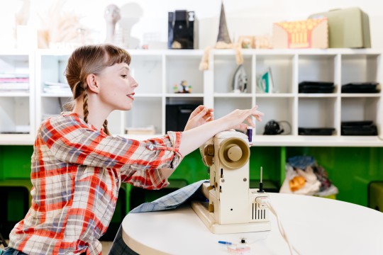 Woman using sewing machine
