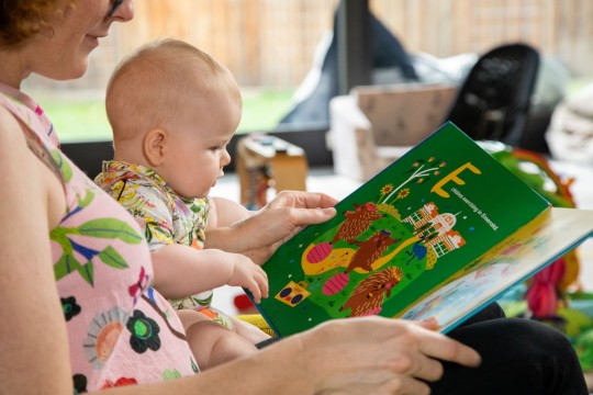 Mother and baby enjoying the book The Little Queenslanders' Alphabet Book 