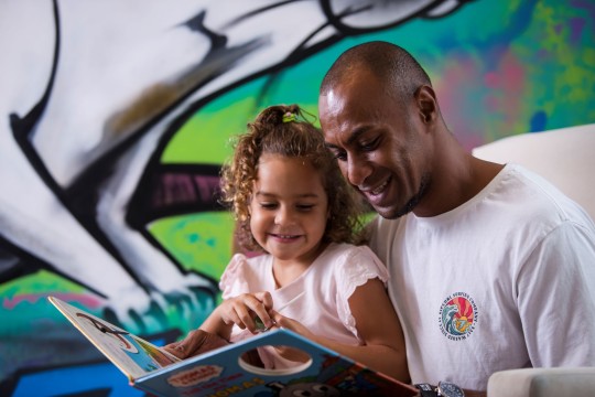 Man and child share book