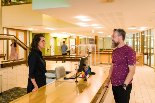 Client interacting with staff at reception