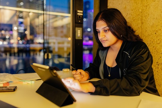 Young woman studies in Window Bay The Edge