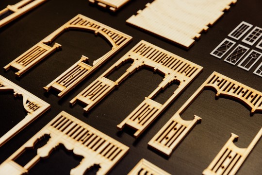 A photo of a row of laser cut miniature archways