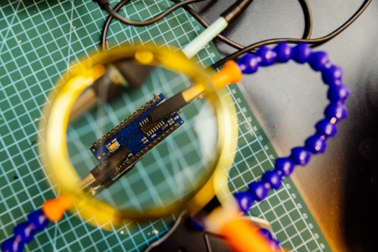 A photo of an arduino electronics board under a magnify glass