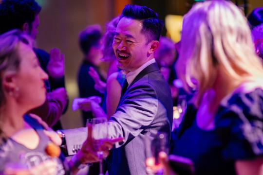 Benjamin Law smiles at another guest at the 2023 Queensland Literary Awards reception