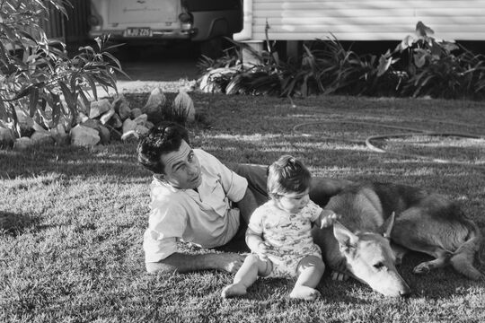 Lido Paganoni and his daughter Phillippa with their dog in the back yard of their house