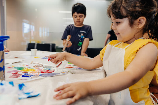 Child paints at a Holiday fun event