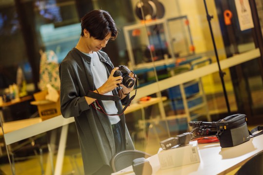 A person holding a DSLR camera