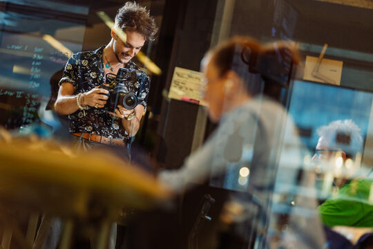 A photo of people through a glass window 