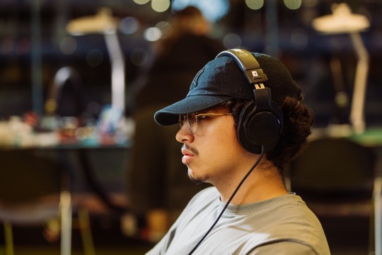 Photo of a person in a cap with headphones on