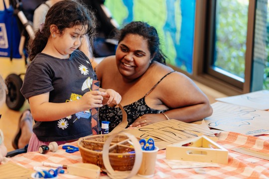 Adult and child participating in a craft activity