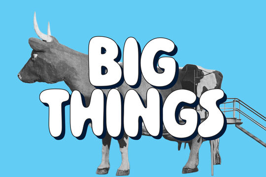 Black-and-white image of a giant cow with stairs, on a bright blue background, with the words “Big Things”.