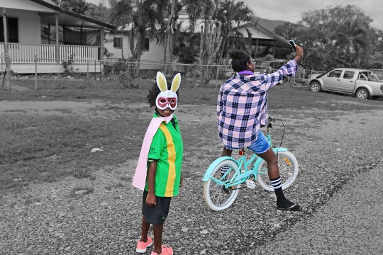 Young girl wearing a bunny mask and her mum taking a selfie outside