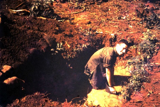 Joe bails water out of  weapons cache Arriving in the wet season meant that the Vietnamese water table was only centimetres below the surface of the ground