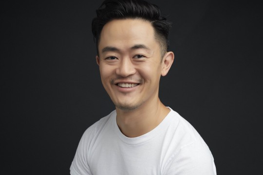 Writer Benjamin Law sitting and smiling