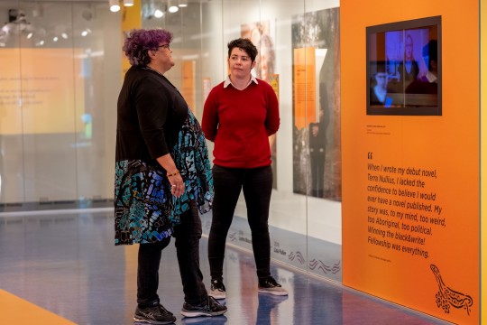 Two women viewing screen at Sovereign Stories exhibition