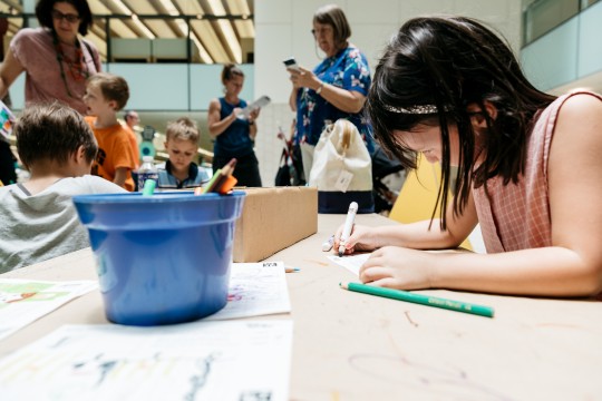 Girl making craft in the Knowledge Walk