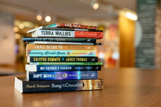 A stack of books by blackwrite authors taken in State Library