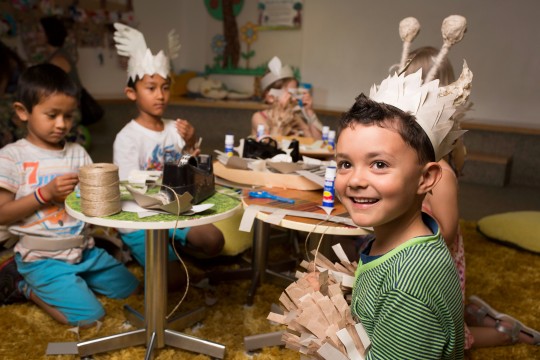 Children making paper costumes