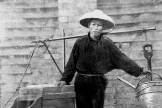 Chinese gold digger with his mining tools suspended from a yoke across his shoulders starting for work in the 1860s