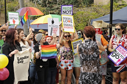 Group of supporters waving placards and banners at the rally