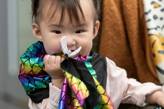 Child with multicoloured cape