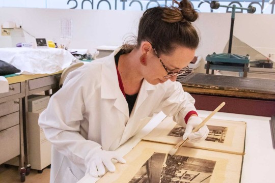 Woman conserving State Library collections
