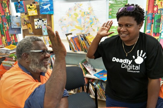 Two people giving each other a 'high five' in a IKC 