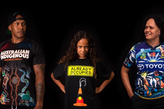 Desktop L to R: Conrad (CJ) Ahwang, a Muluyligal–Zenadth Kes man who is wearing Australian Indigenous Basketball shirt. Shiloh Nakachi, Toik Meriam Samsep woman, residing on Gimuy Walabura Yidinji country at Gimuy (Cairns) wearing a Libby Harward designed "Already Occupied" shirt. Louise Hunter, Girramay, Kuku Nyungul and South Sea Islander woman wearing a North Queensland Cowboys Indigenous Round 2016 shirt. People wearing Indigenous shirts