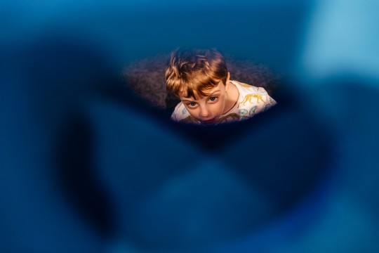Child looking through play object