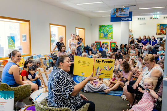 Group of children and parents being read to 