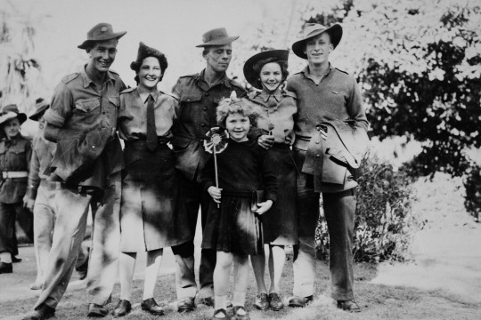 Group of soldiers three men and two women celebrating VJ Day Victory in Japan in the Botanic Gardens Brisbane