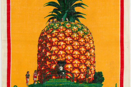 Orange tea towel with an illustration of The Big Pineapple