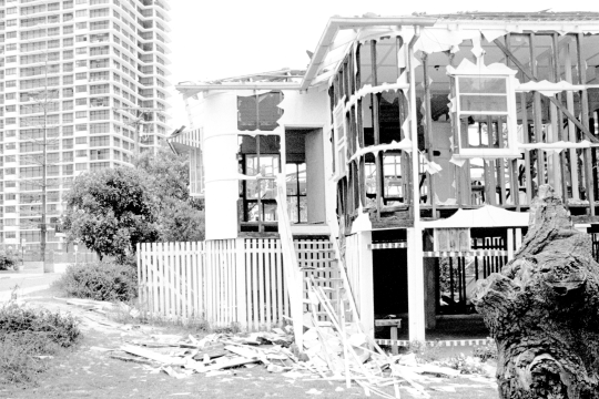 Demolished frame of a house in Surfer Paradise A high-rise appartment block is visible behind ca1970s