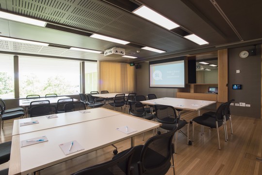 Heritage Collections Learning room set with tables chairs and a projector