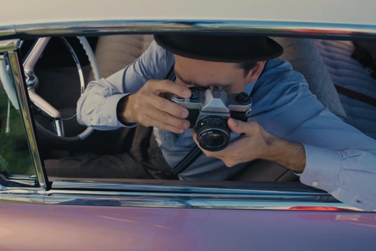 Home exhibition man with camera in a car