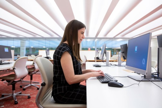 Woman logging into a State Library computer in the Infozone.